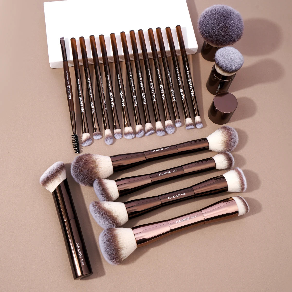 A set of professional makeup brushes including foundation and eyeshadow brushes in various shades and sizes.