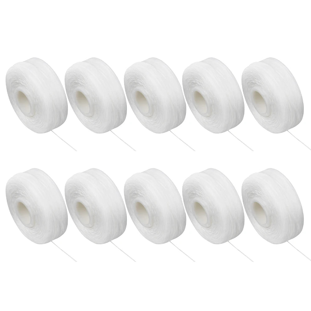 A collection of white dental floss spools for oral hygiene.