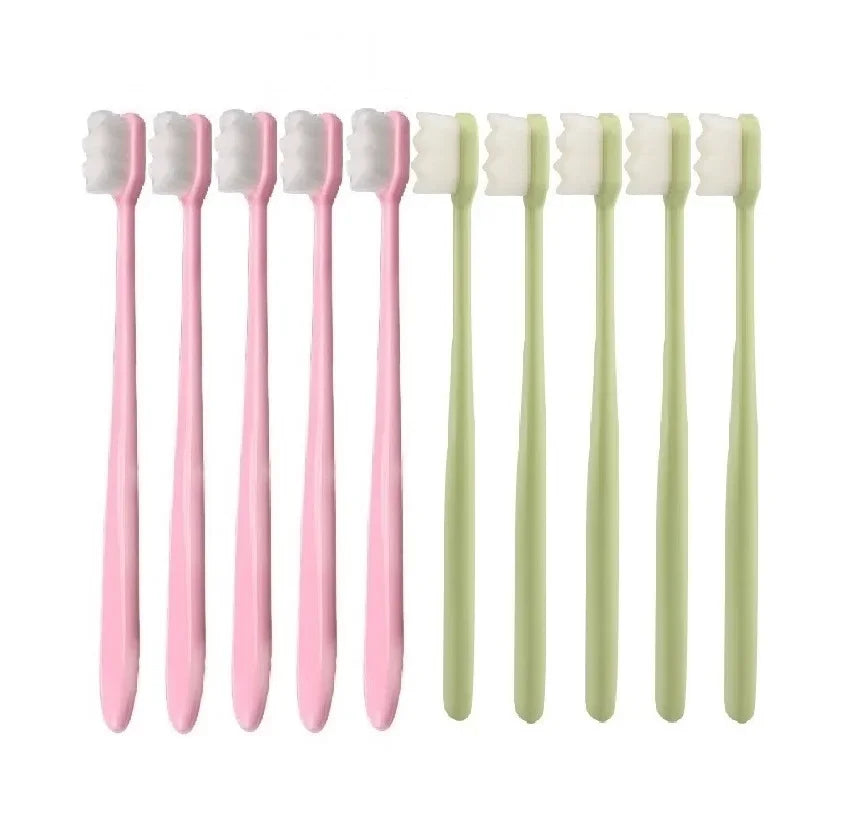 A set of ten pink and light green ultimate deep cleaning toothbrushes arranged in a row.