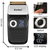 A black precision electric shaver with a silver body, showing the blade replacement button, switch, and LCD display.