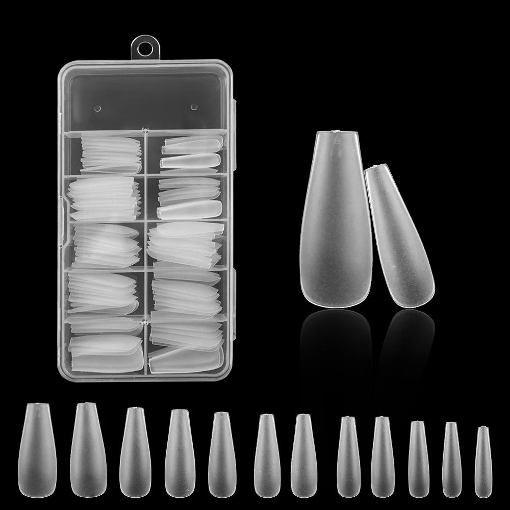 A collection of frosted French false nails in various shapes and lengths displayed in a clear plastic container.