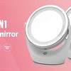 A pair of white LED makeup mirrors, one 1X and one 5X, displayed on a pink background.