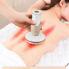 A woman is using an electric meridian brush on her shoulder, demonstrating a massage technique for stress relief.