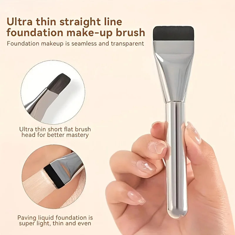 A silver makeup brush is shown next to a hand, demonstrating an ultra thin straight line foundation make-up brush.