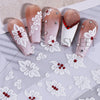 A set of two pink and white floral nail stickers featuring embossed white flowers and red accents.