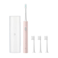 A white sonic electric toothbrush with a pink handle and multiple brush heads shown in various configurations.