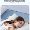 A woman is sleeping comfortably on a blue pillow with silicone earplugs in her ears.