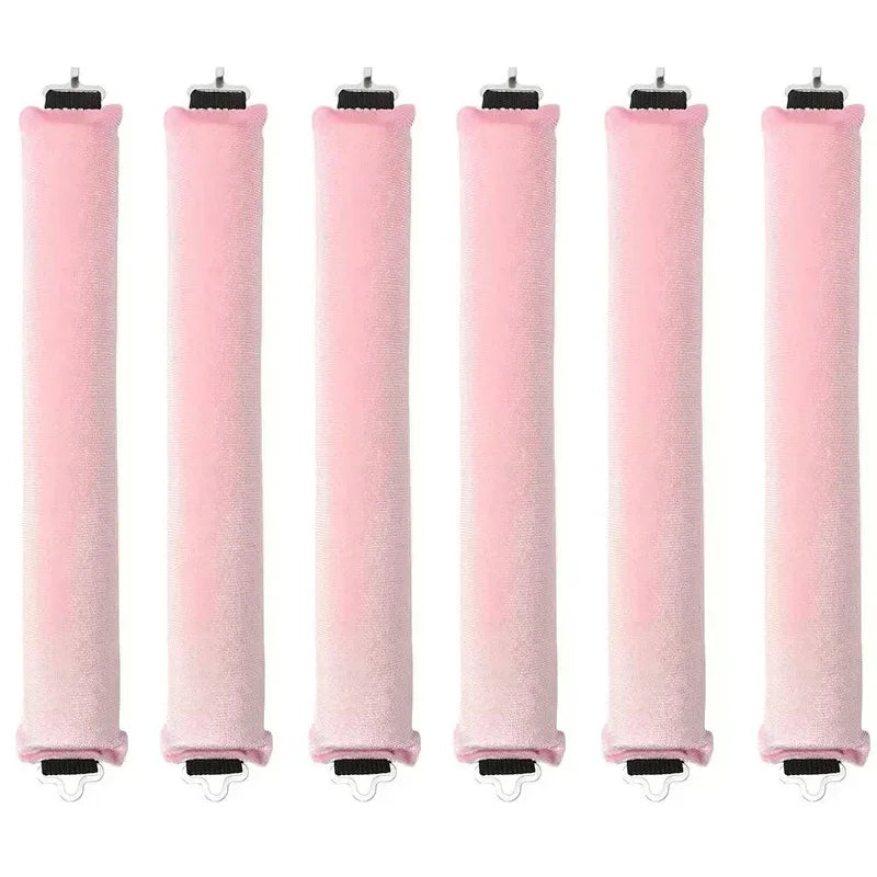 Five pink heatless hair curler curling rods standing vertically.