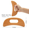 A hand holds a natural wood gua sha roller, showing its shape and dimensions.