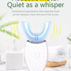 A white sonic electric toothbrush with a blue vibrating head is shown on a marble surface.