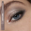 A cosmetic beauty glazed eyeshadow stick is shown next to a close-up of an eye with dramatic smoky blue and gray eyeshadow.