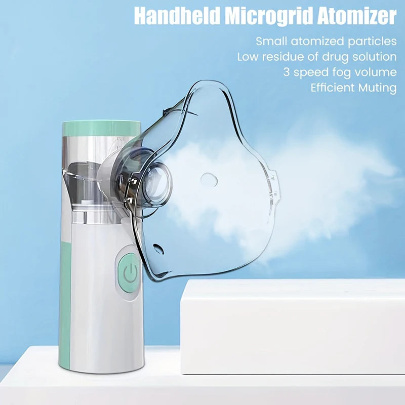 A handheld atomizer device in silver and green is shown next to a white block against a light blue background.