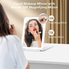 A woman uses an LED rechargeable travel makeup mirror with a round 10X magnifying feature to check her appearance.