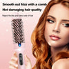 A woman is using a pink heated round hair brush to smooth out frizz and take care of her hair.