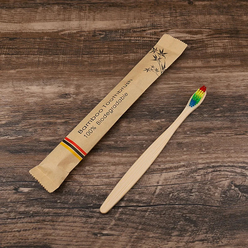 A bamboo toothbrush packaged in natural paper, lying on a wooden surface.