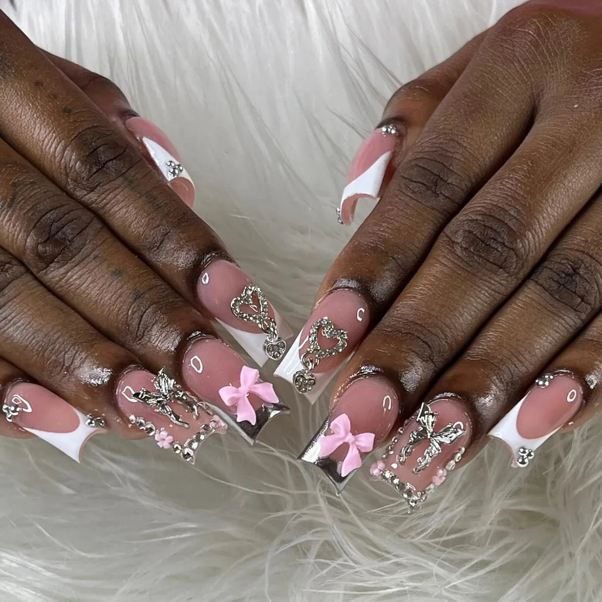 Close-up of hands displaying Y2K sweet stars press-on nails with a blue and brown French wave design.