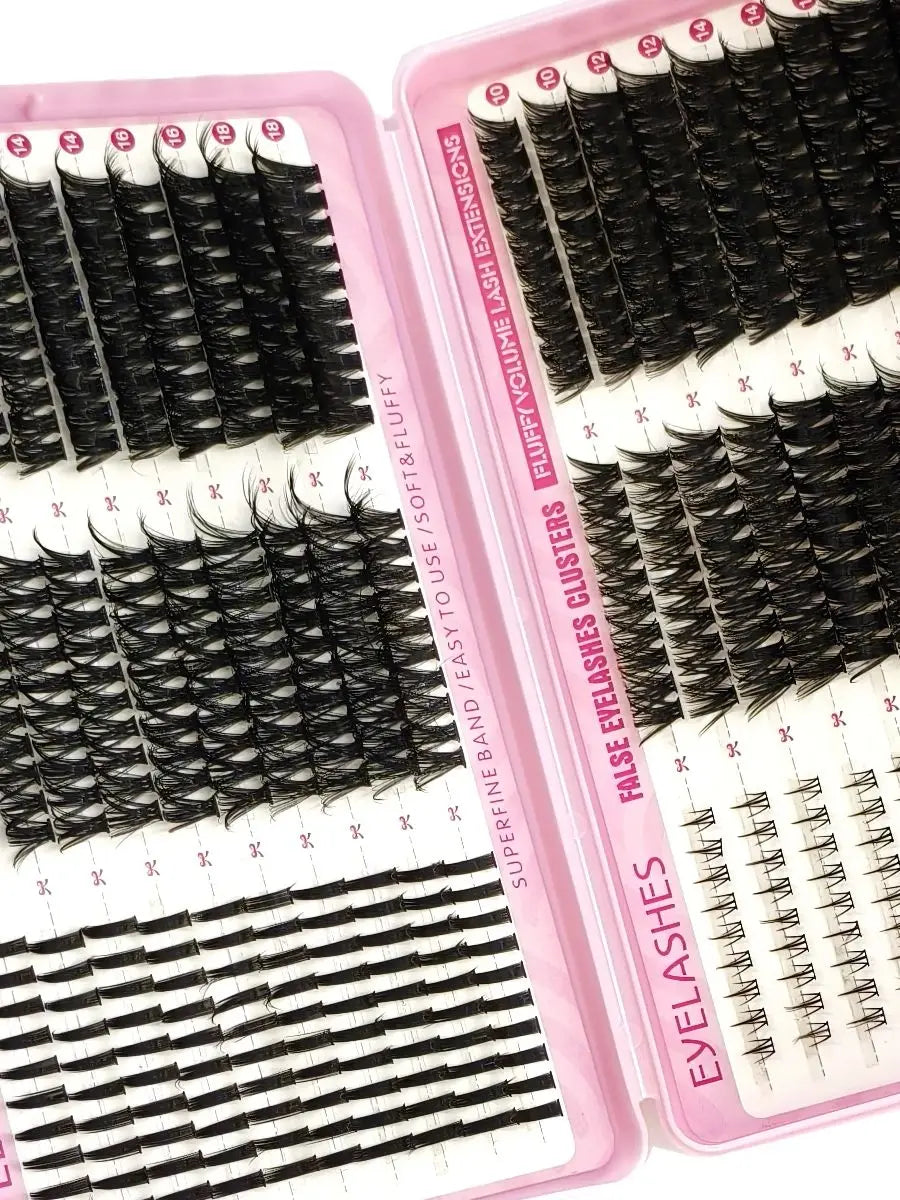 A pink plastic kit containing various false eyelash extensions and lash tools for DIY use