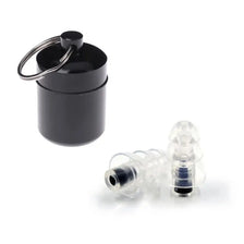 A black silicone earplug with a metal loop is shown next to a clear silicone plug.