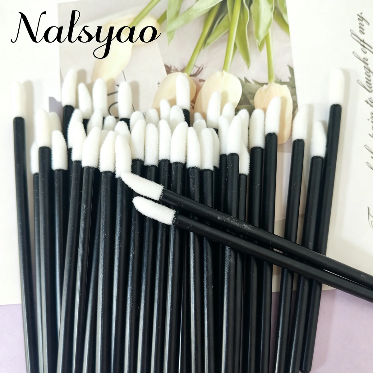 A set of 50 black lip applicator brushes with white tips arranged in a vertical line.