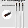 Un set de stylos de photothérapie pour ongles avec poignées noires et pointes brosse, présenté sur un fond gris clair.