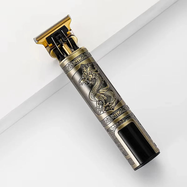 Máquina recortadora de cabello recargable vintage con cabeza dorada y detalles plateados ornamentados.