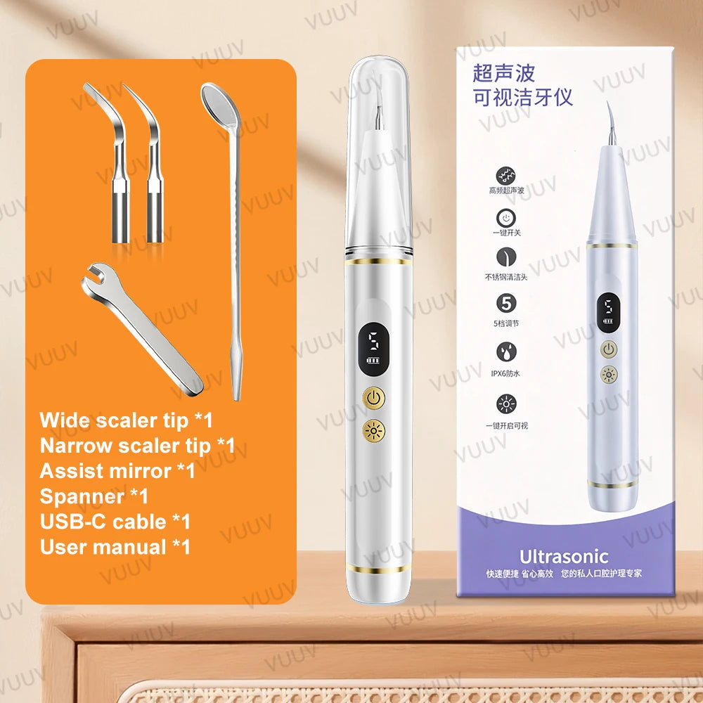 A white ultrasonic dental scaler device is shown next to various dental tools and a manual.