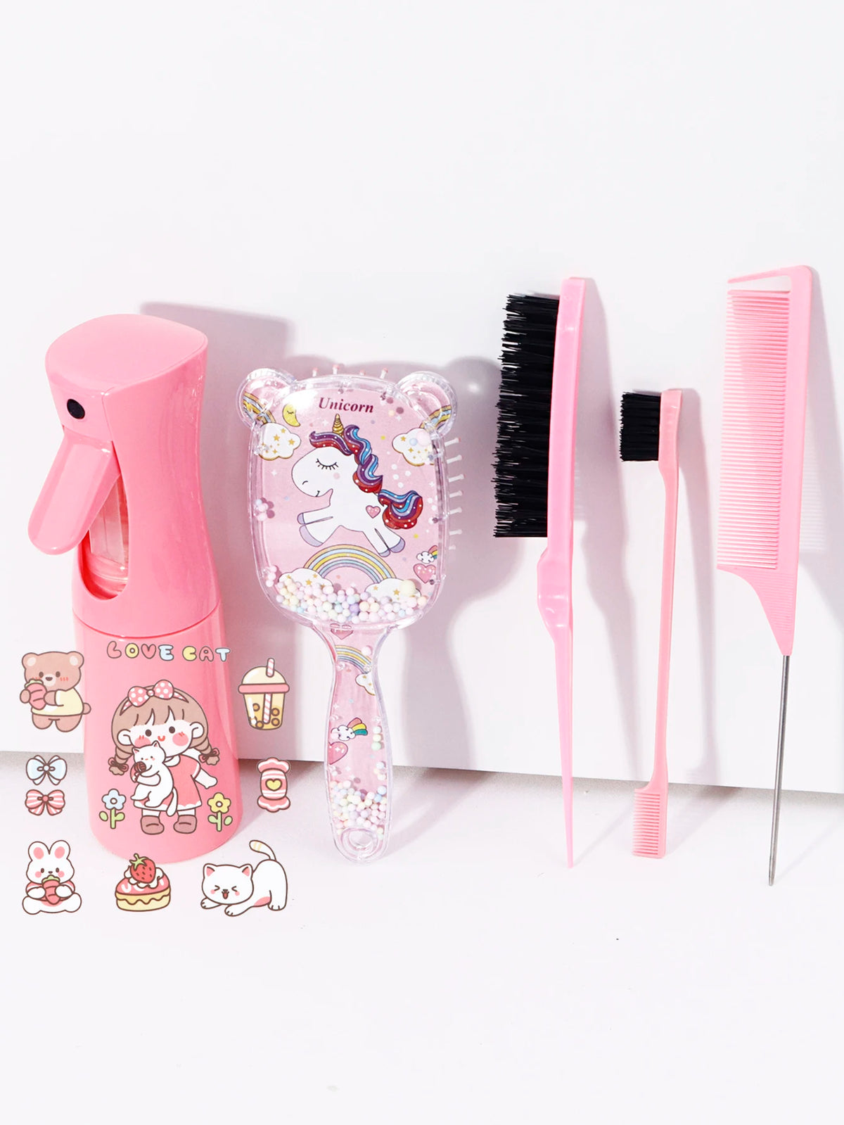A pink unicorn themed hair styling kit featuring a blow dryer, brush, and comb.