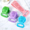 A collection of silicone exfoliating brushes in green, purple, and blue are displayed on a white surface.