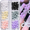 A set of 3D floral butterfly pearl nail art charms in various colors including black, white, yellow, green, and purple.