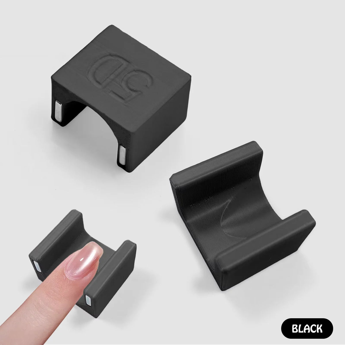 A black 5D cat eye magnet tool for nail art shown from multiple angles.