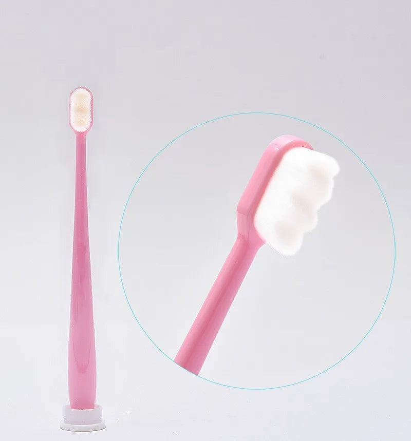 A pink ultra-soft microbristle toothbrush is shown, with a magnified view highlighting the brush head.