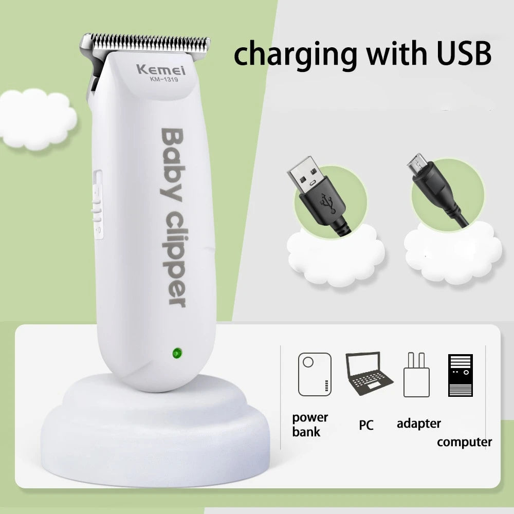 A white Baby clipper is shown charging with a USB cable, placed on a white charging base.
