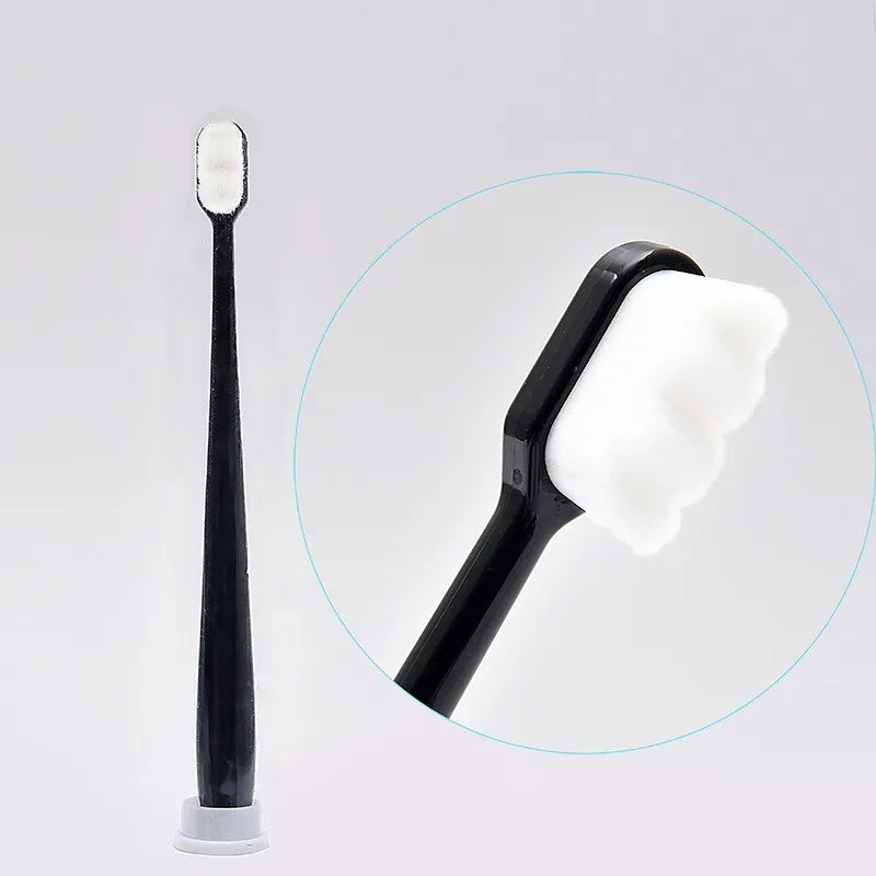 A black ultra-soft microbristle toothbrush is shown next to a magnified view of its soft bristles.
