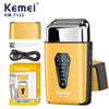 A yellow Kemel KM-T123 electric beard shaver with a silver shaving head and accessories.