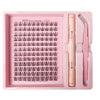 A pink tray containing a DIY lash extension kit with bond, seal, and remover tools.
