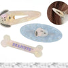A set of three hair clips featuring Snoopy characters in various colors and designs.