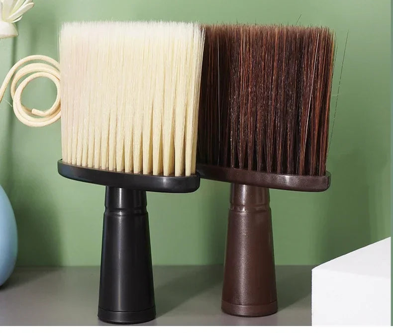 A pair of dark brown and cream soft bristle hair duster brushes displayed on a surface.