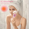A woman is using a pink sonic facial cleansing brush on her face for heating massage and product absorption.