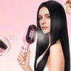A woman holds a pink 2-in-1 hair styling comb and moisturizer spray against her long black hair.