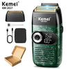 A green and black electric shaver, model KM-2027, is shown with accessories and its packaging box.