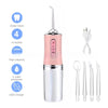 A pink and silver portable USB rechargeable dental water flosser with four nozzles and accessories.