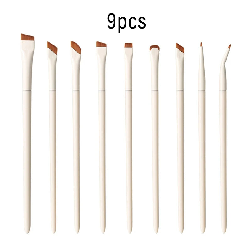 A set of nine precision angled eyeliner and eyebrow makeup brushes in light beige or natural color.