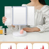 Foldable LED makeup mirror showing different reflectivity levels for vanity use