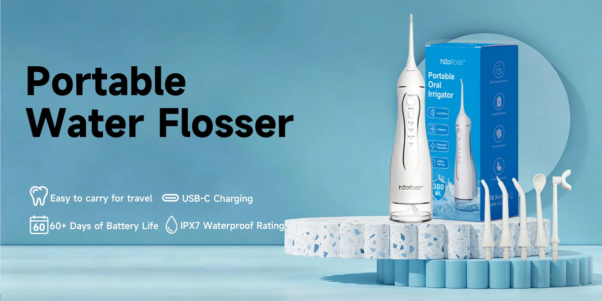 A white portable oral irrigator device is displayed on a blue and white stand with various tips.