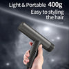 A hand holds a black portable hair styling tool, demonstrating its use for styling the hair.