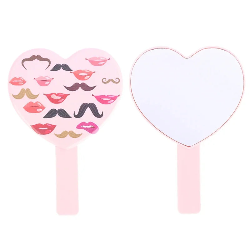Deux miroirs à cils en forme de cœur roses sur bâtons avec divers designs de lèvres et de moustache