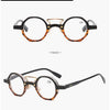 Paire de lunettes rondes à motif léopard noir, vues de face et de profil.