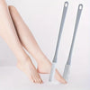 A pair of gray long-handled manual foot scrubbers resting on a white surface.