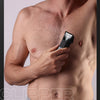 A man is using a 2-in-1 body grooming hair trimmer and epilator on his chest area.