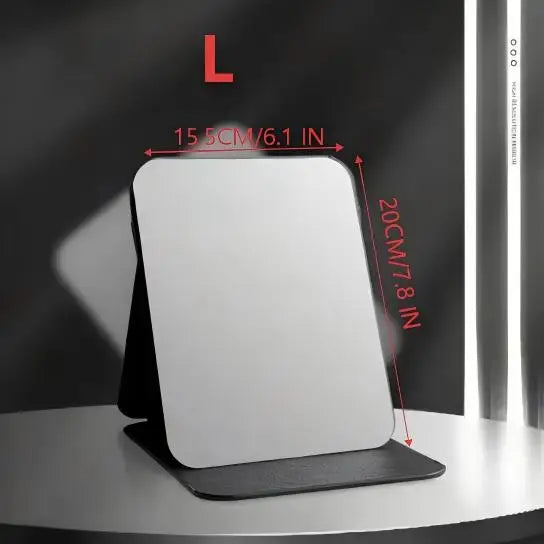 A white foldable portable makeup mirror is shown against a dark background with dimension markings.